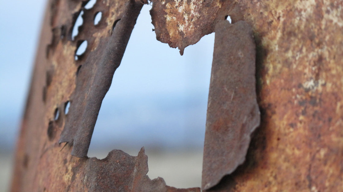 Close up rusted metal with holes
